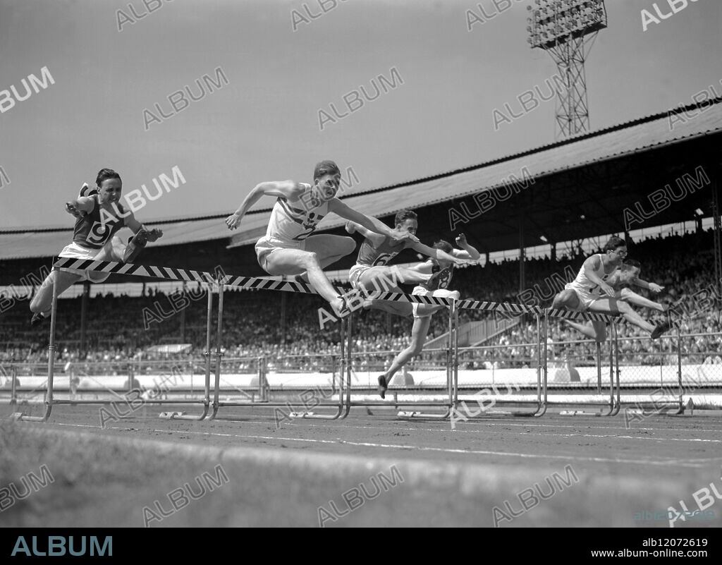Taking a hurdle at International Athletics Meeting 110 metres (Triangular event) Left to Right J P McAslan (Scotland Edinburgh Southern Harriers) F J Parker (England South London Harriers) who was second. J C McVeigh ( Cambridge University) J G M Hart ( Scotland RAF & Atlanta A C ) who (no 8) was third and P B Hilreth (England Polytechnic Harriers) the winner 5th July 1952.
