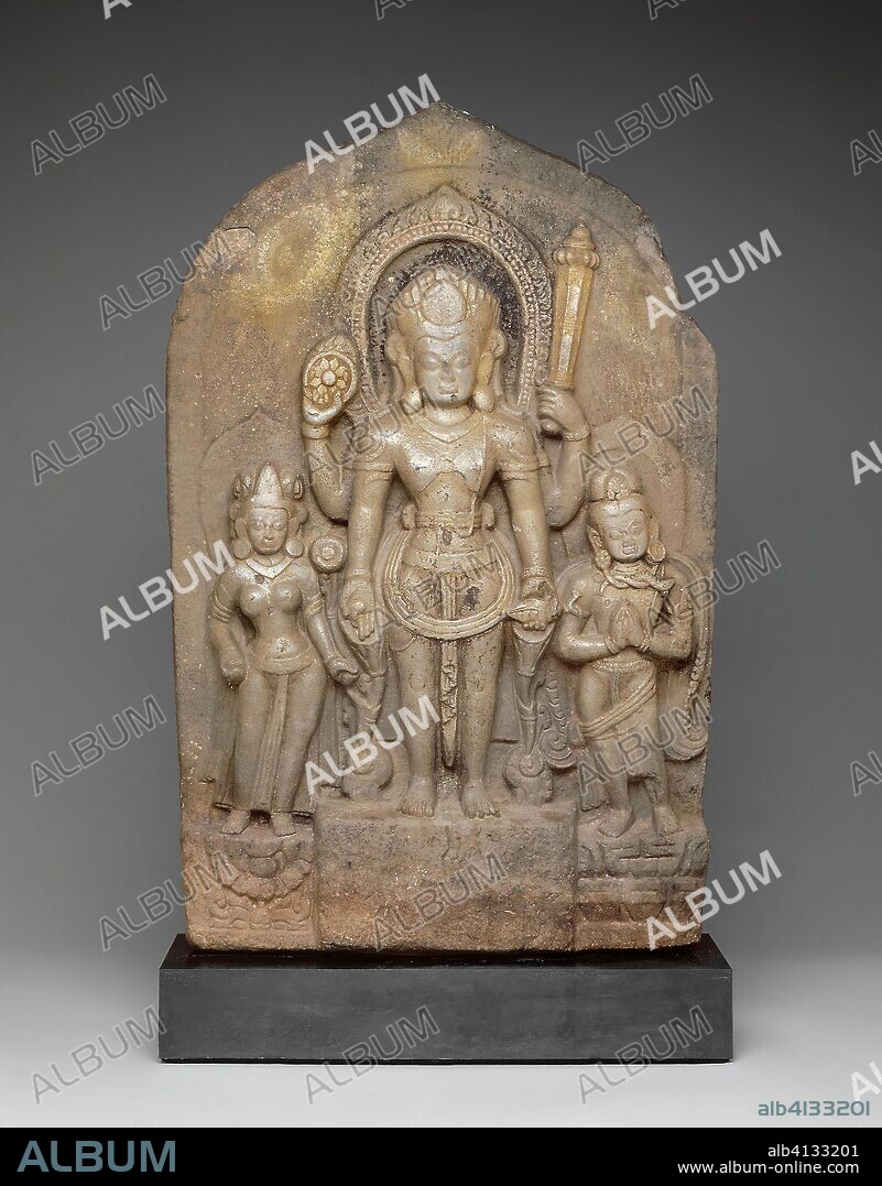 God Vishnu with Goddess Lakshmi and His Mount, Garuda, in Attendance. Nepal; Kathmandu Valley. Date: 1001-1100. Dimensions: 75.8 × 50.3 × 10.8 cm (29 7/8 × 19 13/16 in.). Schist. Origin: Kathmandu Valley.