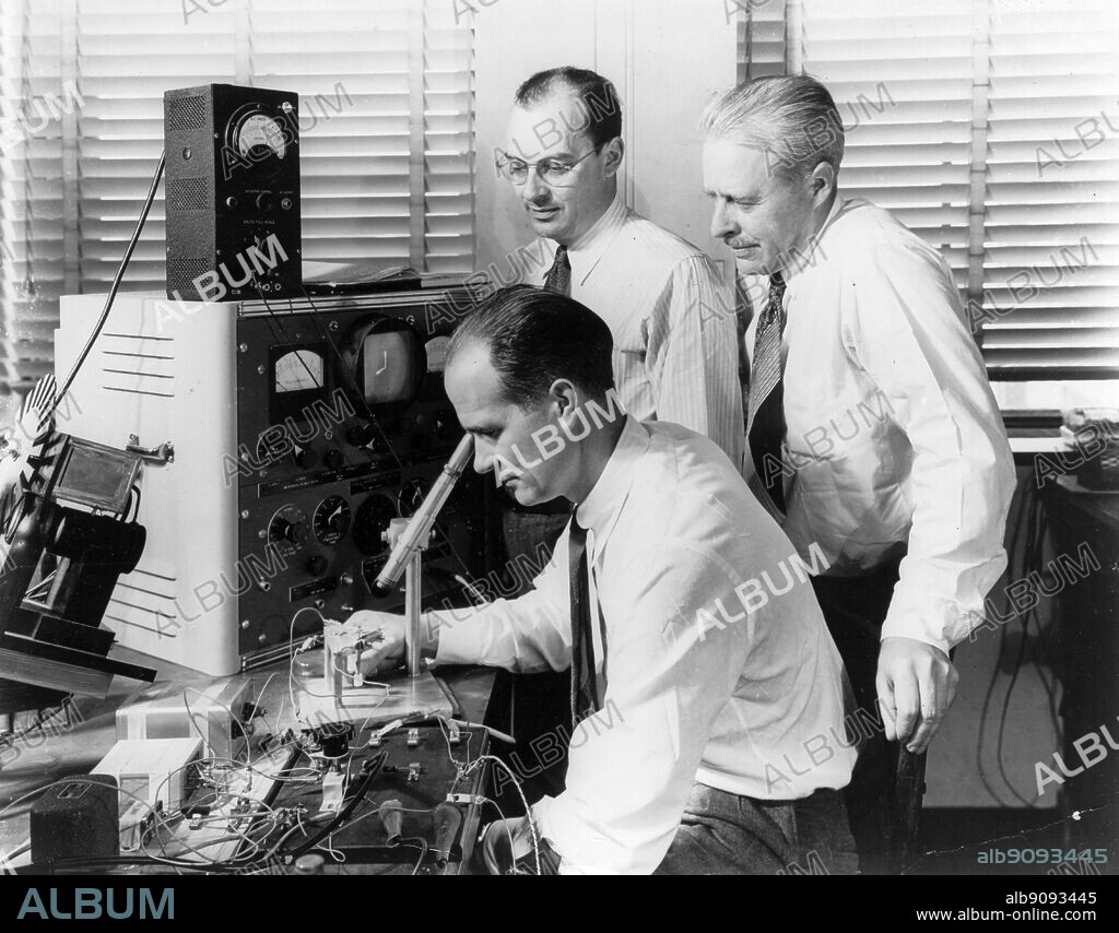 Nobel Prize Winners Drs Wiliam ( William ?) Shockley (seated), John Bardeen (left) and Walter H Brattain, at Bell Telephone Laboratories in 1948 with the apparatus used in the first investigations that led to to the invention of the transistor, which was announced by Bell Laboratories in 1948.