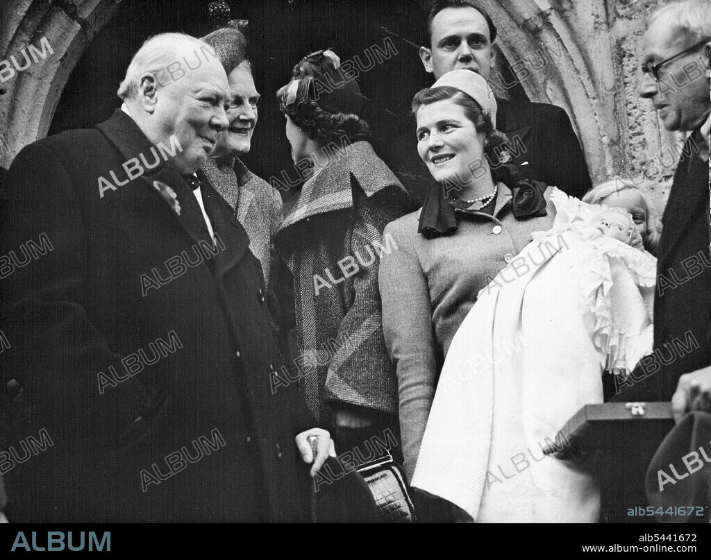 Churchill Attend Christening -- Left to Right: Winston S. Churchill; Mrs. Clementine Churchill; unidentified woman; Mrs. Mary Soames with the baby; unidentified man on the porch of the church after the ceremony. At rear is the father, Captain Christopher Soames. British Conservative leader Winston S. Churchill and his wife Clementine attended the Christening of their grandchild, two-month-old daughter of Captain Christopher Soames and the former Miss Mary Churchill, at the 13th century Parish Church at Fletching, Sussex, England, this afternoon November 6. The baby was Christened Emma Mary. November 6, 1949. (Photo by Associated Press Photo).