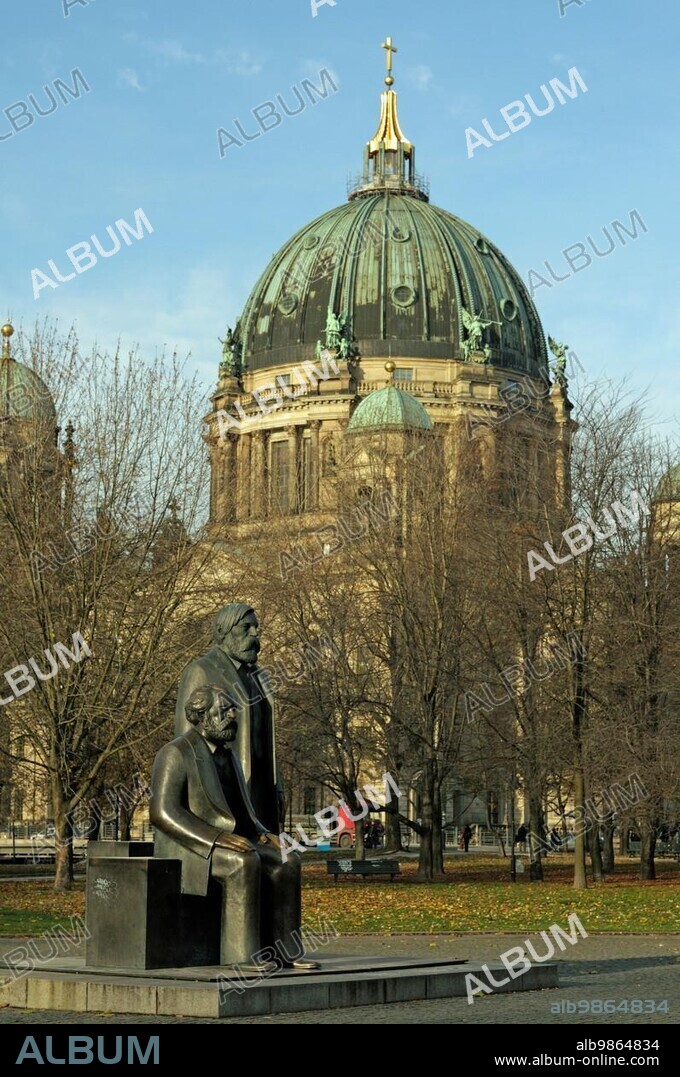 The Marx-Engels-Forum is a monument complex built in the 1980s in Berlin-Mitte. It is located between Spandauer Straße and the Spree River, close to Berlin's city hall, the ?Red City Hall? Since the 1980s, the bronze sculptures of Karl Marx and Friedrich Engels had stood at the Red Town Hall. Now they have to make way for the construction site for the underground railway. The old centre of Berlin is changing its face once again. The statues of Karl Marx (foreground) and Friedrich Engels at Marx-Engels-Forum. In the back.