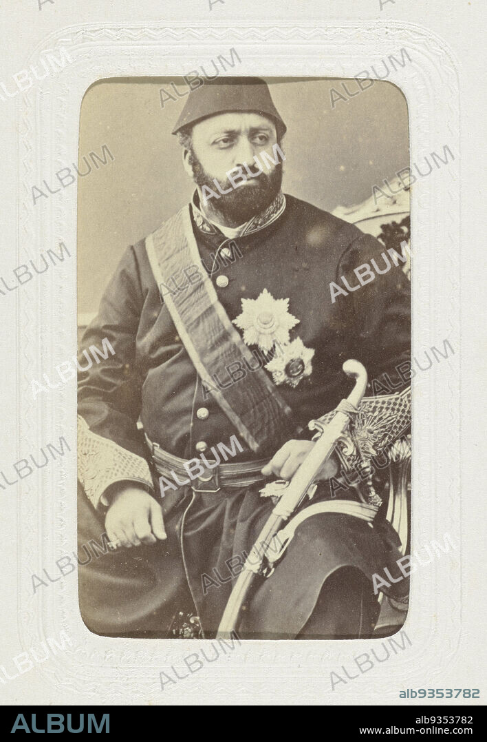 Studio portrait of a stout man in army uniform with insignia on his chest and a sword on his belt, On his head the man wears a fez., Abdullah Frères (mentioned on object), Istanboel, c. 1863 - c. 1866, paper, cardboard, albumen print, height 80 mm × width 54 mmheight 296 mm × width 225 mm.
