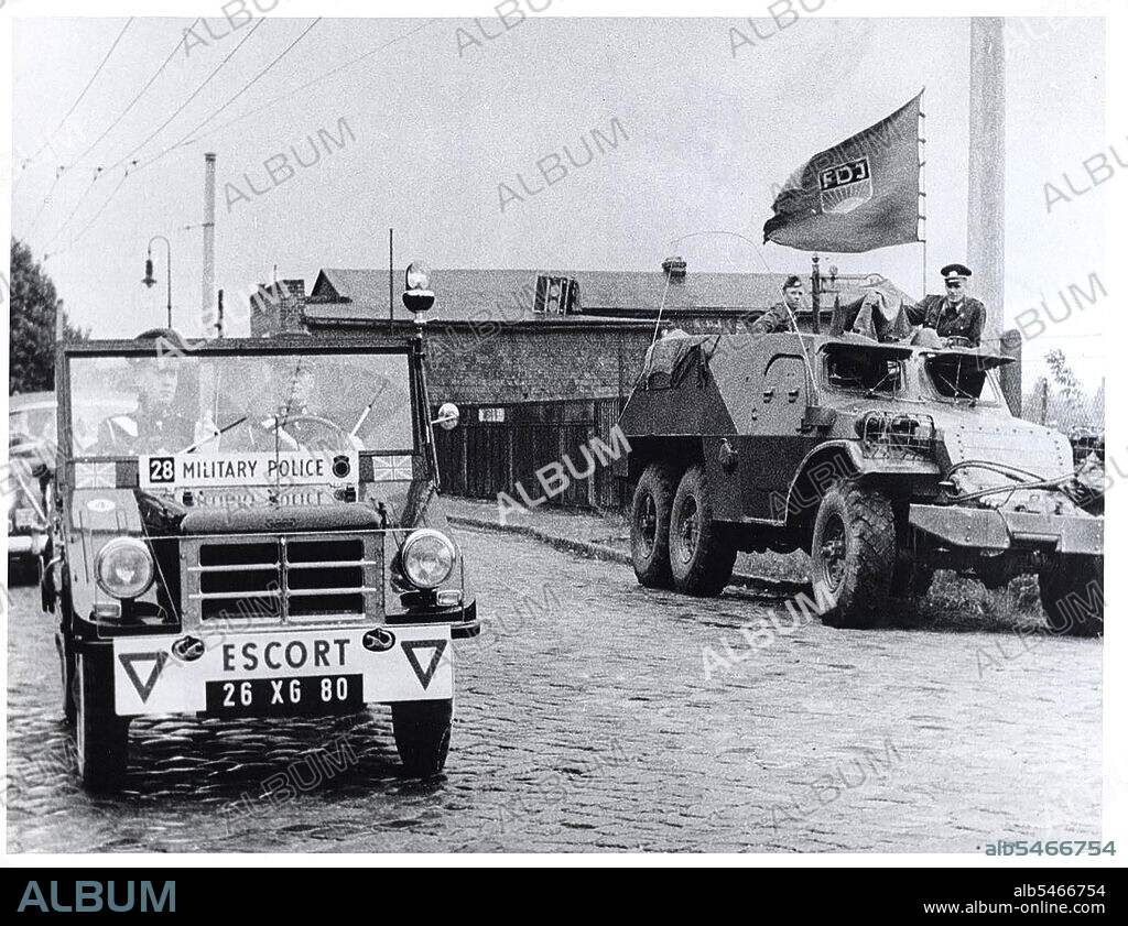 Berlin Wall Photo -  August 1961 - British Motorized Patrol Passes Communist East German Armored Car On A Street Bordering West and East Berlin..