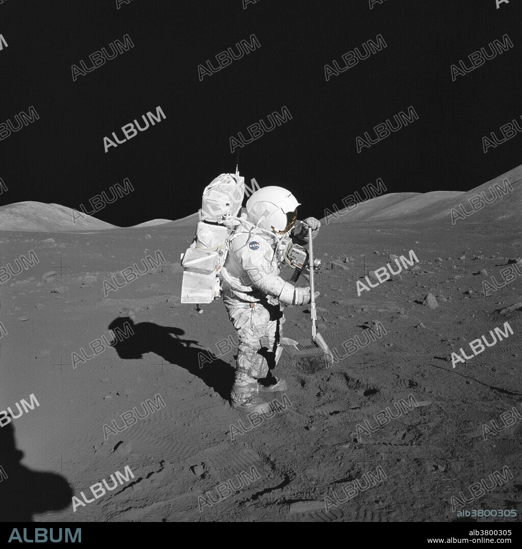 Scientist-astronaut Harrison H. Schmitt, lunar module pilot, collects lunar rake samples at Station 1 during the first Apollo 17 extravehicular activity (EVA) at the Taurus-Littrow landing site. This picture was taken by astronaut Eugene Cernan, commander. The lunar rake, an Apollo lunar geology hand tool, is used to collect discrete samples of rocks and rock chips ranging in size from one-half inch (1.3 centimeter) to one inch (2.5 centimeter).