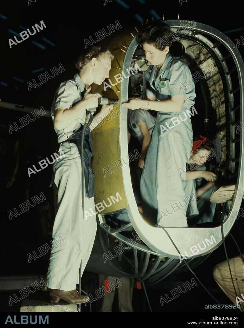 HOWARD HOLLEM. Riveters at work on fuselage of Liberator Bomber, Consolidated Aircraft Corp., Fort Worth, Texas.
