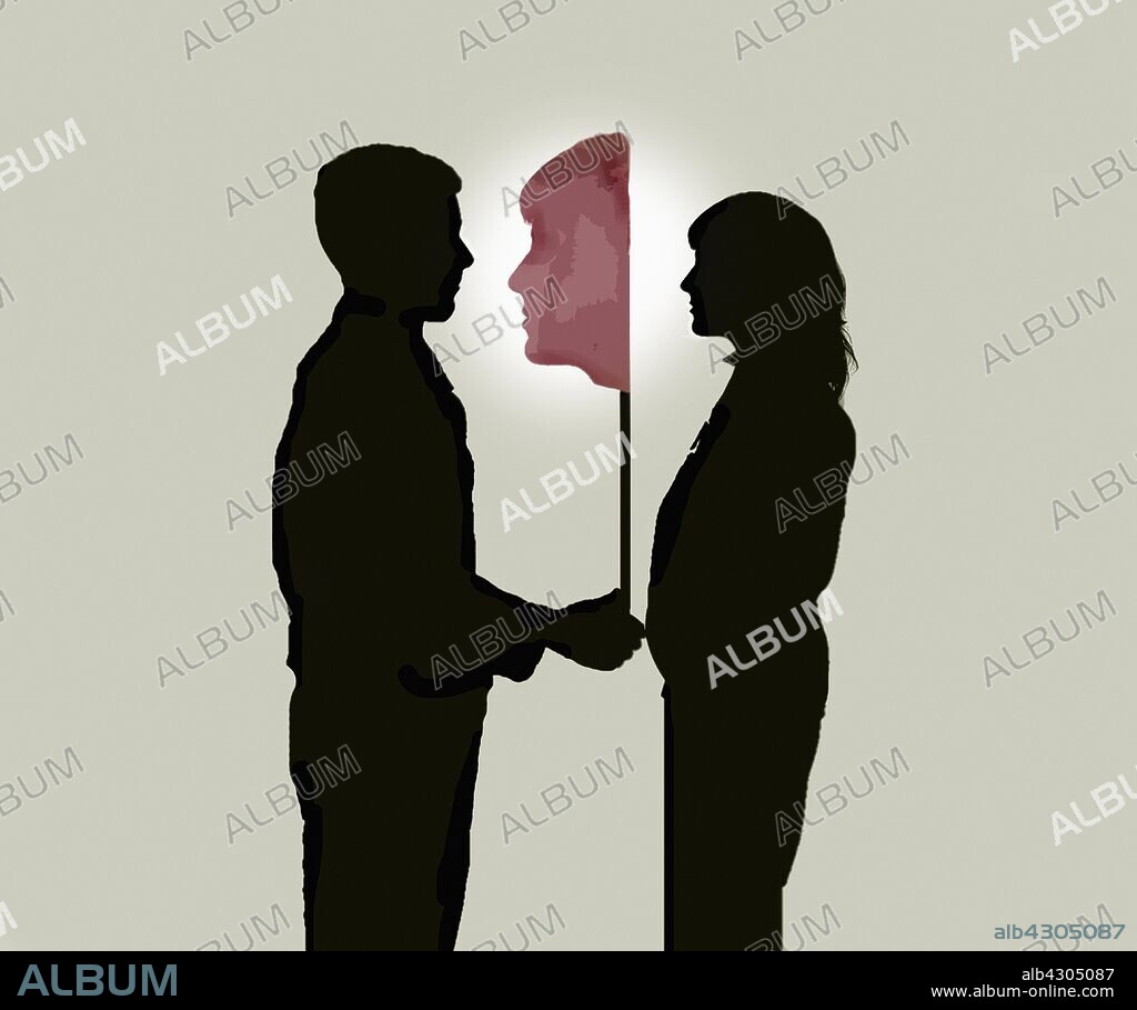 Man holding mask in front of woman's face.