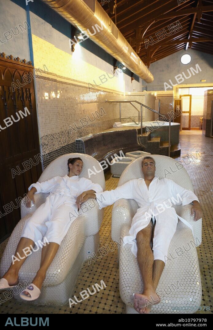 Couple relaxing on hot stone seats, spa-relais. Lierganes hotel and spa, Cantabria, Spain.