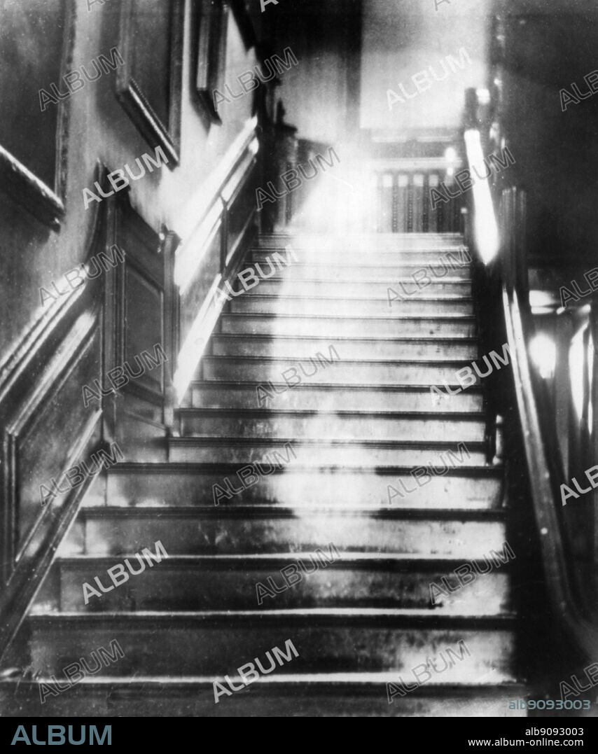 The Brown Lady descending the staircase at Raynham Hall Norfolk the home of Marquess of Townshend.