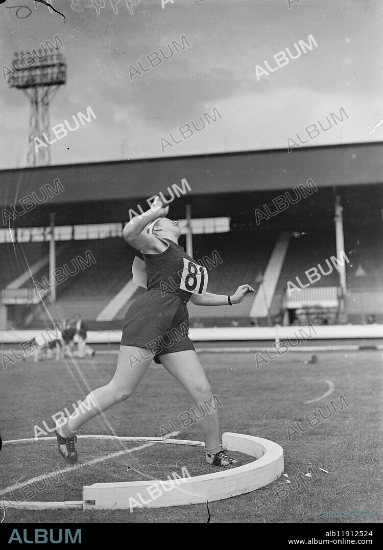 Women athletes compete in championships at White City. The Women's Amateur Athletic Association championships took place at the White City, London. Two hundred competitors took part. Photo shows, Bevis Reid of Mitcham Athletic Club setting a new record of 37 Feet in the shotput. 2 July 1938.