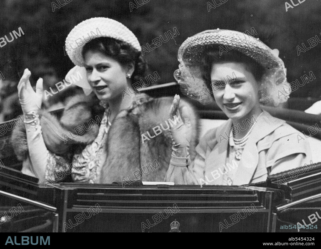 Royal Greeting at Royal Ascot : Princess Elizabeth (left) and her sister, Princess Margaret, waving a greeting to racegoers as they arrive at Ascot racecourse for the last day of the meeting. June 18, 1948.