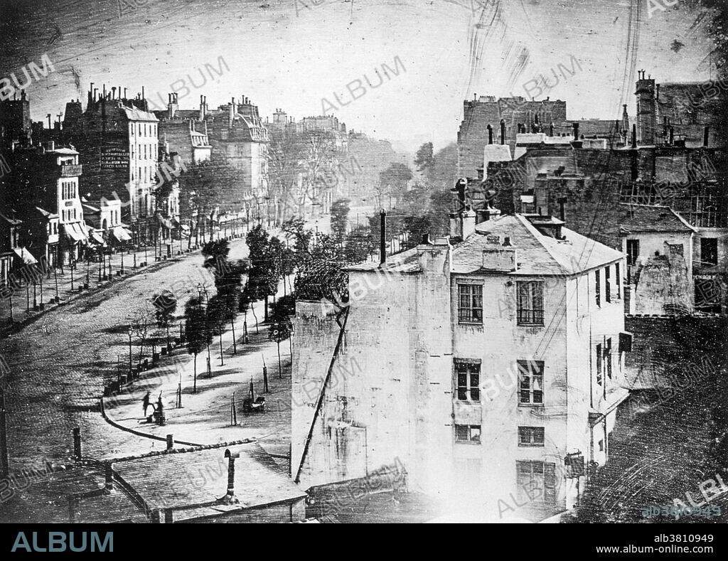 Boulevard du Temple, taken by Daguerre in 1838 in Paris, includes the earliest known candid photograph of a person. The image shows a street, but because of the over ten-minute exposure time the moving traffic does not appear. At the lower left, however, a man apparently having his boots polished, and the bootblack polishing them, were motionless enough for their images to be captured. Louis Daguerre (1787-1851) was a French artist and photographer, recognized for his invention of the daguerreotype process of photography. The daguerreotype process, or daguerreotypy, was the first publicly announced photographic process, and for nearly twenty years it was the one most commonly used.