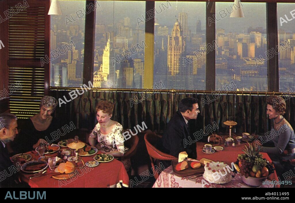 Top of the Rock restaurant, Prudential Building, Chicago, Illinois, USA, 1960. An intimate, club-like atmosphere high above Chicago's busy streets. The city's skyline is visible through the windows. The 44 storey building opened in 1955. Today it is known as One Prudential Plaza.
