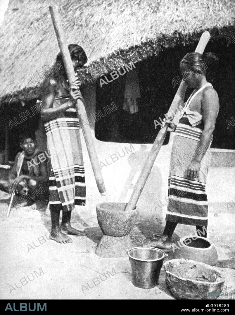 Newar women pounding grain, Nepal, 1936. The Newar are an indigenous people of the Kathmandu Valley. From Peoples of the World in Pictures, edited by Harold Wheeler, published by Odhams Press Ltd (London, 1936).
