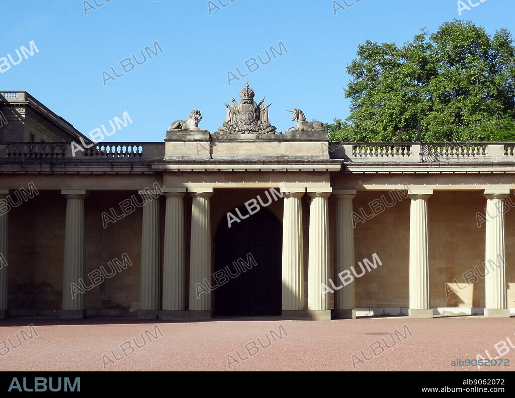 Royal Crest with lion and Unicorn adorn a courtyard inside Buckingham Palace, London, England.