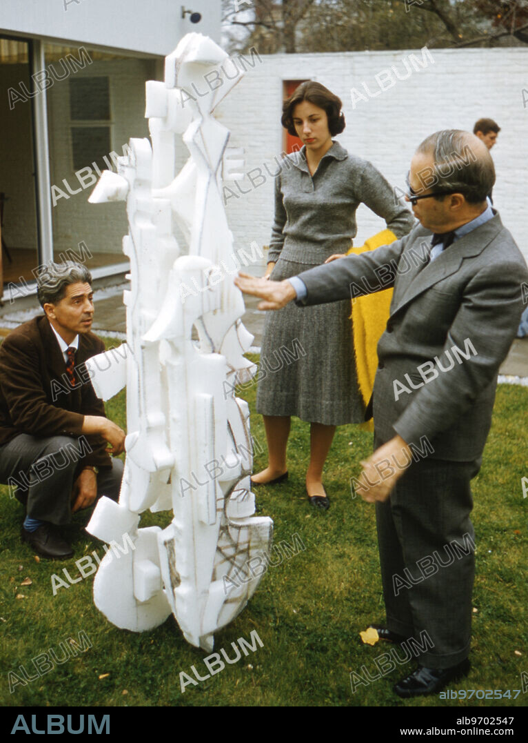 Mirko Basaldella, at left, showing one of his Styrofoam models to Josep Lluís Sert in the courtyard of Casa Sert in November 1958. Casa Sert was a home designed by Josep Lluís Sert, and which he used as his residence. ,Image: 755013950, License: Rights-managed, Restrictions: , Model Release: no, Credit line: Phillip A. Harrington / Avalon.