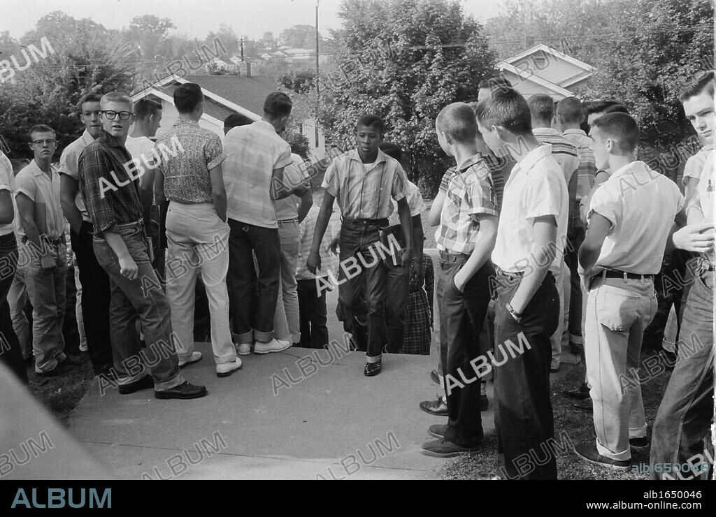 School integration conflicts, Little Rock, Arkansas. Photograph shows an African American boy walking through a crowd of white boys during a period of violence related to school integration. 1957. Thomas J O'Halloran, photographer.