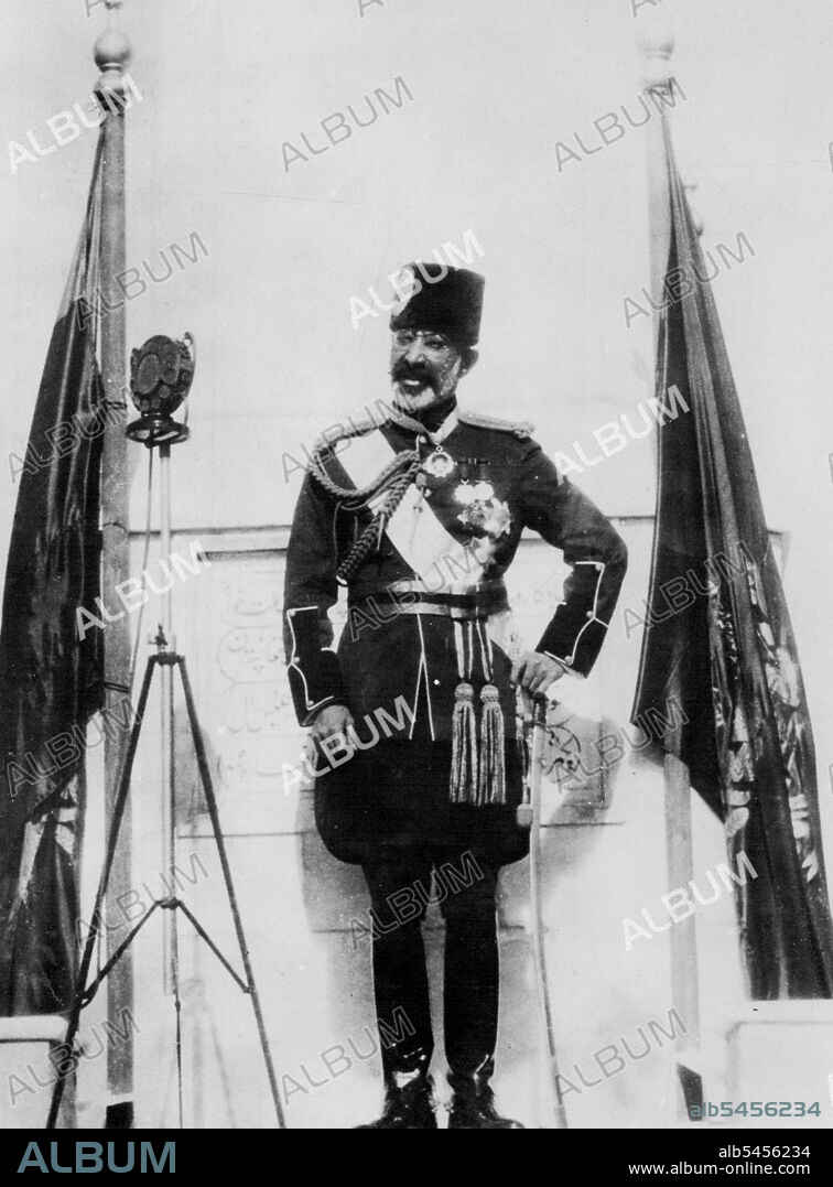 Afghanistan Celebrates Independence Day -- A close - up of his Majesty King Nadir Khan, of Afghanistan, making his royal speech on the occasion of the celebration of Independence Day recently. On both his sides are the National flags of Afghanistan. -- Afghanistan is the wilde stretch of country on the north of India. September 19, 1933. (Photo by Keystone).