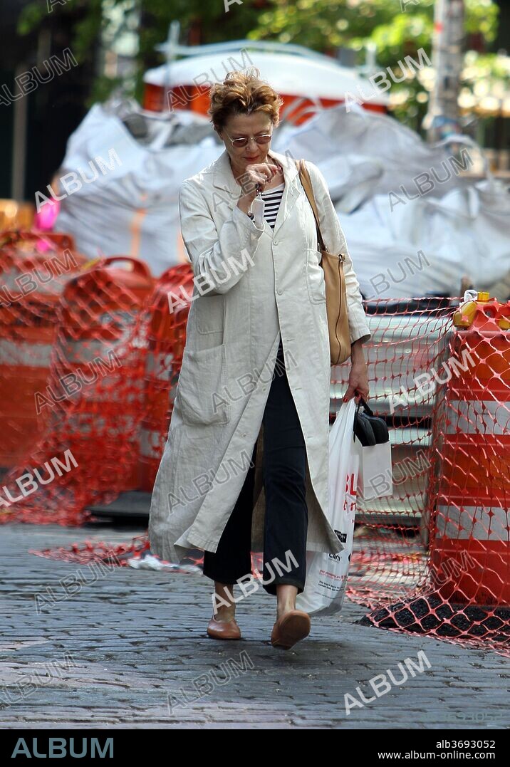 May 10, 2018 - New York, New York, United States - Actress Annette Bening buttons up in a long white coat as she waks in the West Village on May 10 2018 in New York City. 10/05/2018