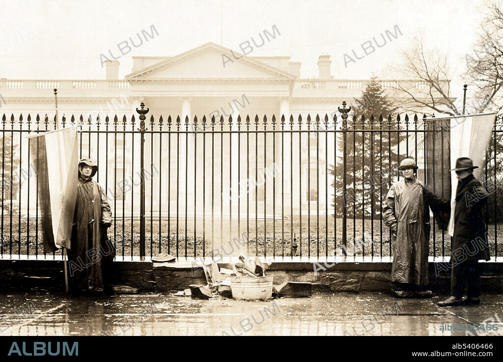Suffragettes with bonfire in front of White House. The Silent Sentinels were organized by Alice Paul and the National Woman's Party. They protested in front of the White House during Woodrow Wilson's presidency starting on January 10, 1917 and ending on June 4, 1919 when the Nineteenth Amendment to the Constitution was passed. Harris & Ewing, 1917 (cropped and cleaned).