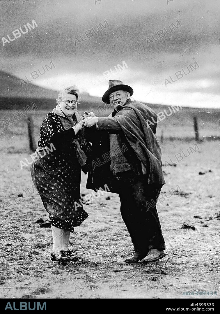 Negative - Beveridge District, Victoria, circa 1931, Copy negative of a couple dancing after three days of heavy rain broke an extended drought in the early 1930s. Francis (Frank) James Smith and Bridget Smith owned a mixed farm called Mt Fraser, near Beveridge, Victoria. The photograph was taken by a photographer from The Sun newspaper, Melbourne. The couple had previously farmed in Tower Hill, Victoria and moved to Beveridge in 1913. They had.