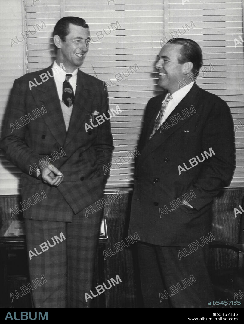 Chips Rafferty and Sidney J. Albright Managing Director of 20th Century-Fox photographed in the latter's office this morning after it was announced that Rafferty had been selected to play one of the featured roles -- Sgt, East -- in "Desert Rats." Chips will leave for Los Angeles on October 30th and the picture will go into production shortly after his arrival. November 13, 1952.