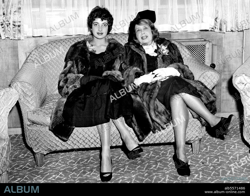 Disastar: A Laddered Stocking on a Famous Leg - Mistinguett, the iron butterfly, the indestructible, the deathless vamp, who, it is said, is roughly 20 years older than the Eiffel tower is pictured in London with her niece. Mistinguett (of the legendary legs - she has a ladder in her right stocking) has come to London to launch her book of memoirs.The famed Mistinguett, the queen of the Paris music-hall who has refused to abdicate, the darling of the Folies Bergere, who numbered four kings among her admirers, is around 80 thought she doesn't look it.She wears a heavy mink coat, which sports a large orchid on the lapel, which a black hat. As Mistinguett raised the hem of her skirt revealing her black silk slightly laddered stockings, her niece Mlle. Micky pulled her own skirt further down. Mlle. Micky is an actress -- but not in music--hall.October 10, 1954. (Photo by Sunday Express Picture).