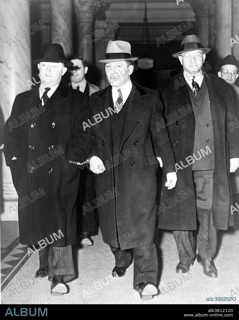 Louis "Lepke" Buchalter, center, handcuffed to J. Edgar Hoover, on the left, with another man on the right, at entrance to courthouse. Louis Buchalter (February 6, 1897 - March 4, 1944) was an American mobster and head of the Mafia hit squad Murder, Inc. during the 1930s. He was one of the premier labor racketeers in New York City during that era. Buchalter became the only major mob boss to receive the death penalty in the United States after being convicted of murder. John Edgar Hoover (January 1, 1895 - May 2, 1972) was the first Director of the Federal Bureau of Investigation (FBI) of the United States. Appointed director of the Bureau of Investigation - predecessor to the FBI - in 1924, he was instrumental in founding the FBI in 1935, where he remained director until his death in 1972 at age 77. Photographed by Al Aumuller of the New York World-Telegram & Sun Newspaper, 1939.