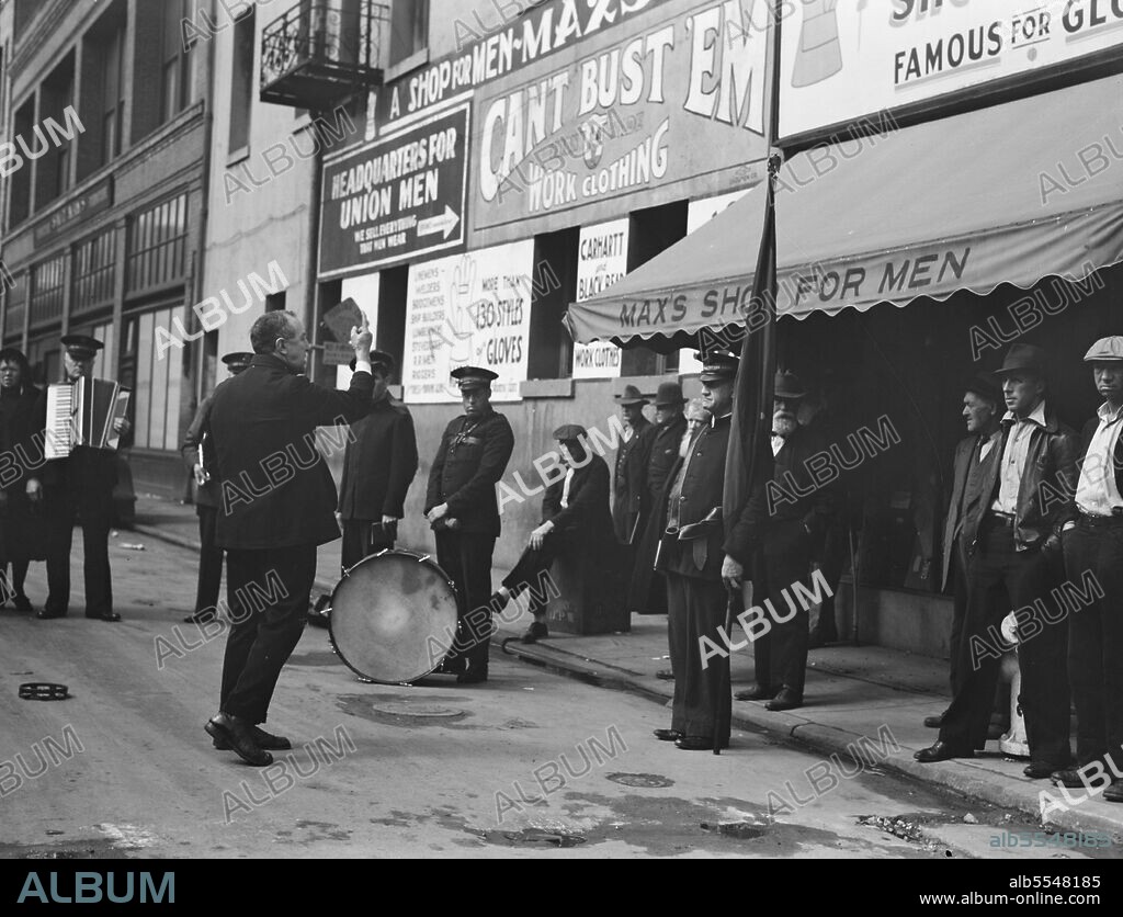 DOROTHEA LANGE. Preaching to the crowd. Salvation Army, San Francisco, California. [Signs: 'Headquarters for Union Men - We Sell Everything That Men Wear; Can't Bust 'Em Work Clothing; Max's Shop For Men'].