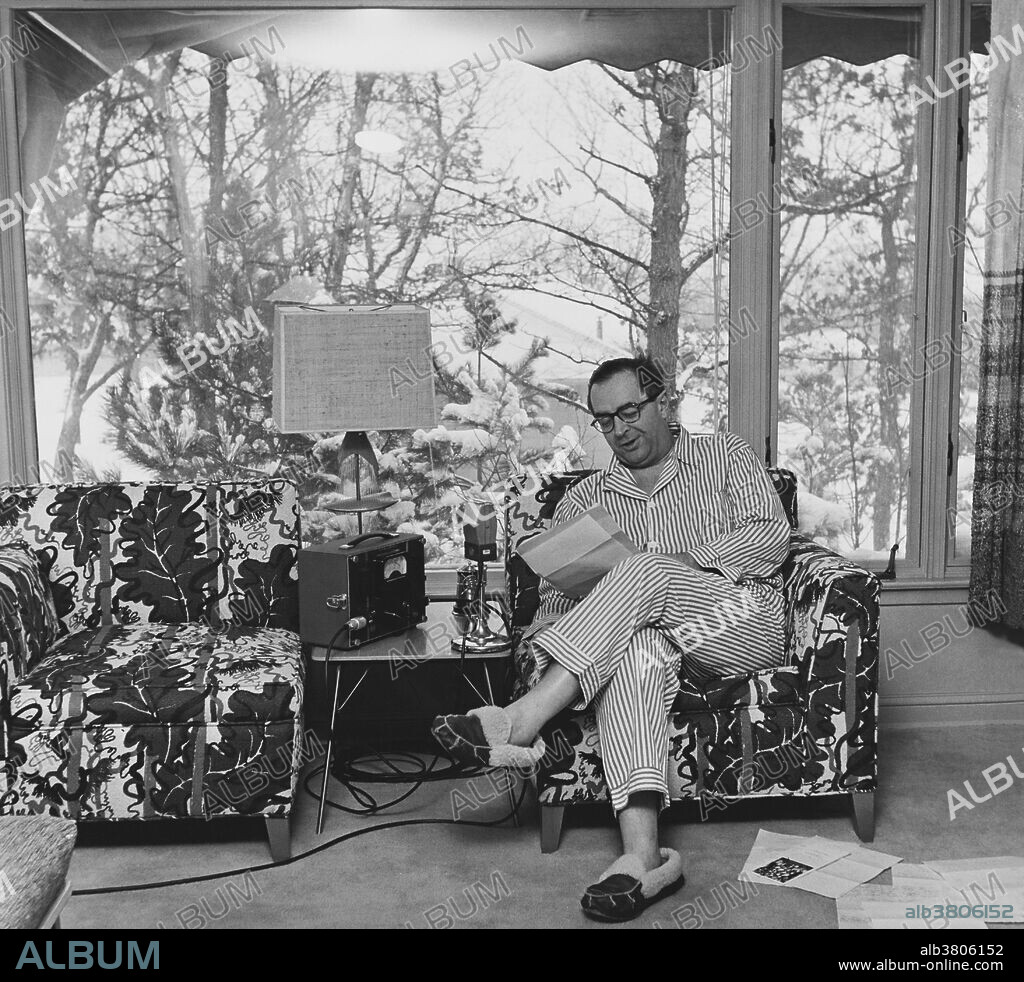 Cedric Adams (1902-1961), American commentator and columnist, doing his folksy broadcast from his own house, located slightly outside the city limits in Minneapolis, Minnesota, 1960.  In 2002, he was inducted into the Pavek Museum of Broadcasting's Hall of Fame.