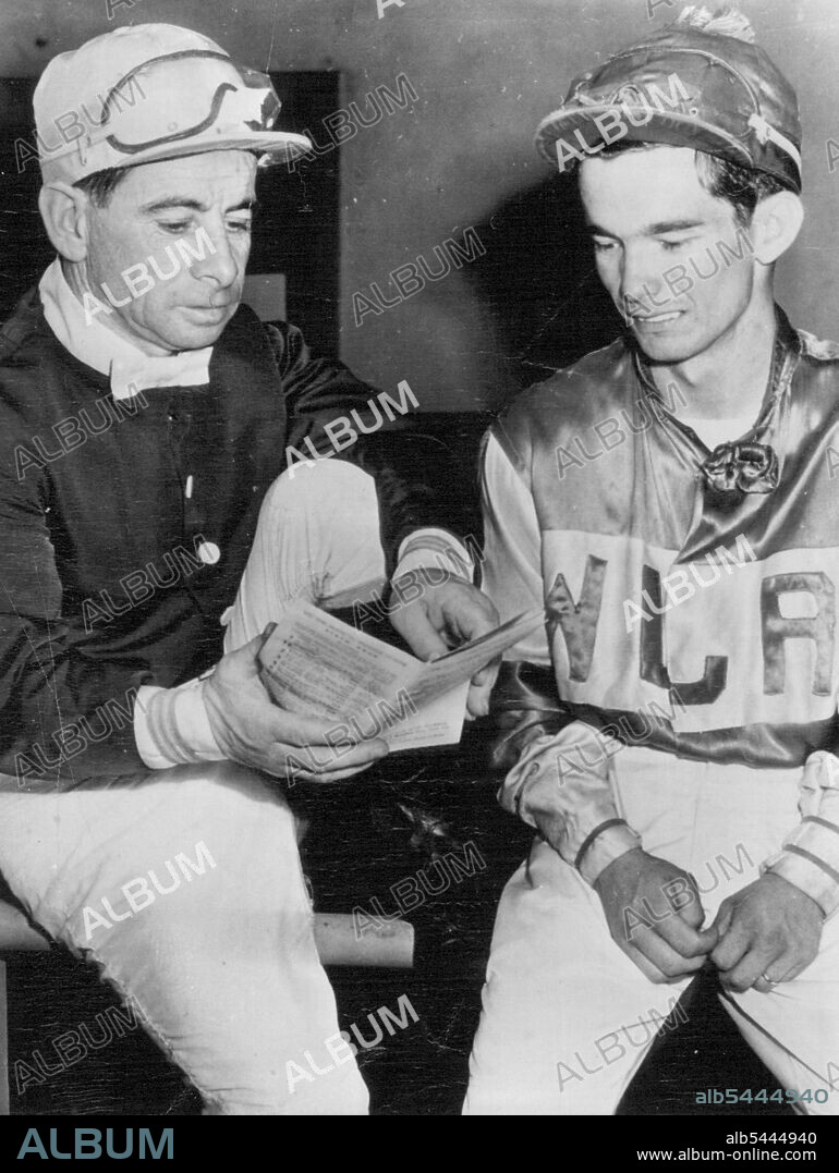 Old Champ and New -- Jockey Willie Shoemaker (right) talks over the day's Hollywood Park card with the veteran Johnny Longden after the 19-year-old Texan yesterday brought home his 321st winner this season, eclipsing Longden's modern American record of 319 in one year. Shoemaker, who has been riding less than two years has developed a riding style similar to that of Longden. November 11, 1950. (Photo by AP Wirephoto).