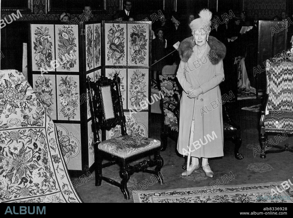 Queen Mary Opens Needlework Exhibition, Royal School, At St. James' Palace Queen Mary standing by some of her own embroidery work at today's opening. H.M. has four works on show: the carpets, the screen and the chair. Queen Mary's latest work is dated 1950. Queen Mary today opened an exhibition of embroidery by the Royal School of Needlework at St James' Palace. The Coronation Robes are also on view. April 12, 1951. (Photo by Fox).