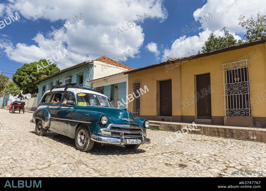 A vintage 1950's American car working as a taxi in the town of Trinidad, UNESCO World Heritage Site, Cuba, West Indies, Caribbean, Central America.