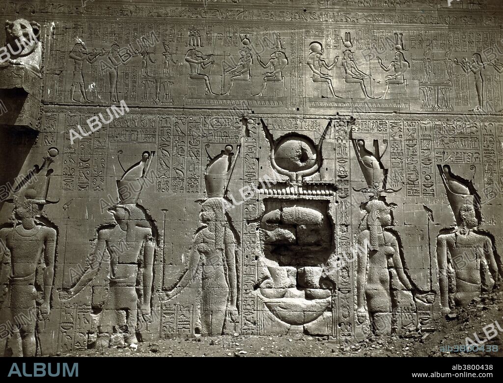 Entitled: "Bas-relief and hieroglyphics cover wall in the Temple of Hathor, located in Dendara, Egypt." Dendera Temple complex is one of the best-preserved temple complexes in Egypt. The whole complex covers almost 10 acres and is surrounded by a hefty mud brick enclosed wall. Dendera was a site for chapels or shrines from the beginning of history of ancient Egypt. The all overshadowing building in the Complex is the main temple, namely Hathor temple (historically, called the Temple of Tentyra). The temple has been modified on the same site starting as far back as the Middle Kingdom, and continuing right up until the time of the Roman emperor Trajan. The existing structure was built no later than the late Ptolemaic period. The temple, dedicated to Hathor, is one of the best preserved temples in all Egypt. Photographed by FÃ©lix Bonfils, circa 1870-80.