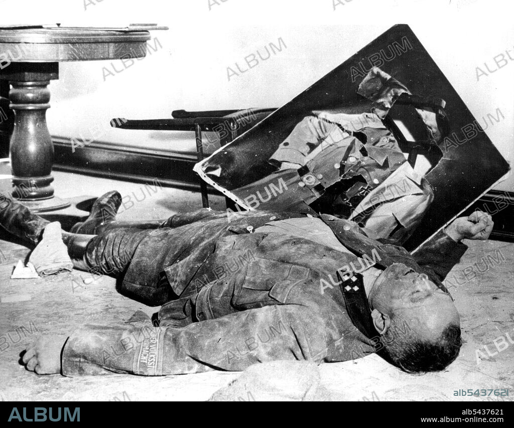 Twilight Of The Nazis -- This was the end of the path of Nazi Glory for one Volkssturm general, who slashed a portrait of Hitler before killing himself. Scene is at the Leipzig Town Hall. A wave of suicides swept over the higher Nazi echelons as the ring of allied Armies closed in on the heart of the third Reich. This May 7th will be the tenth Anniversary of the signing of the unconditional surrender by the German high command at Reims, France. Though there was still the Japanese enemy in the Pa.
