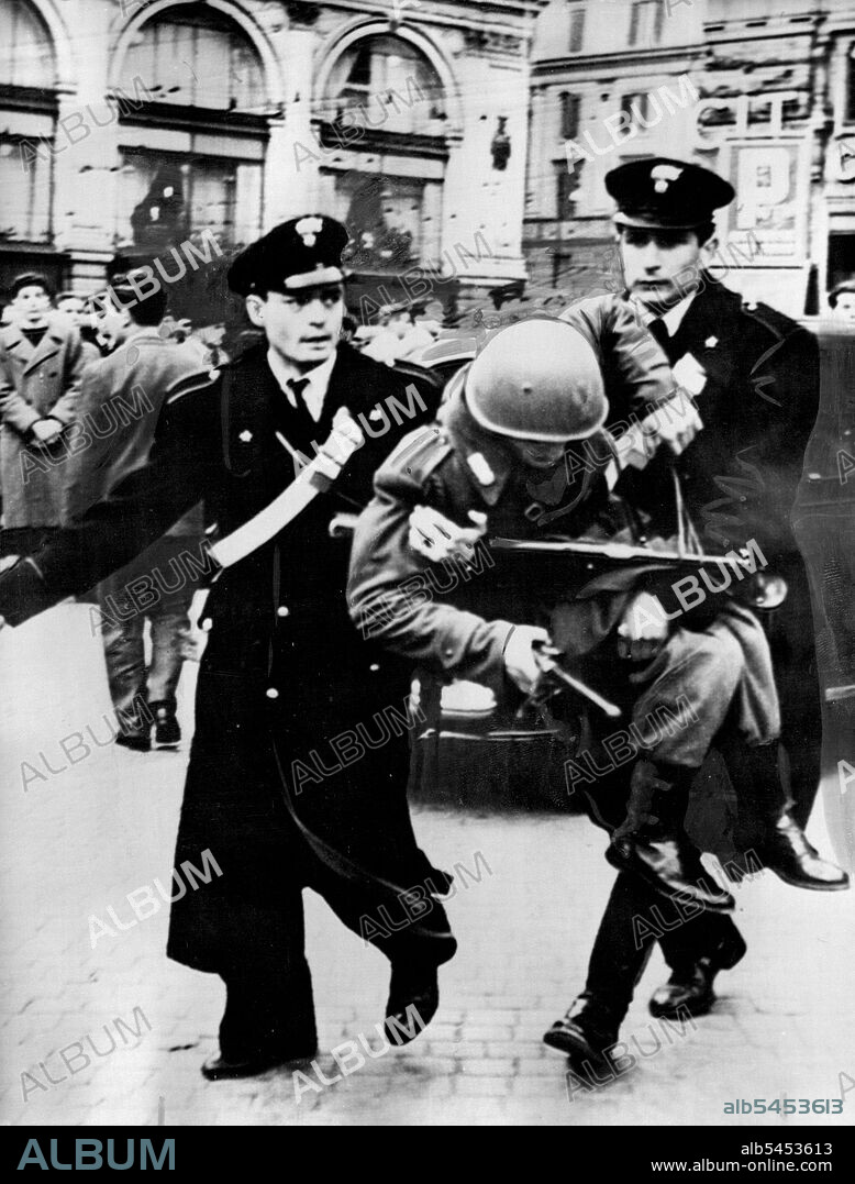 Roman Demonstrate For TriestTwo Carabinieri carry a wounded Roman policeman, still holding on to his club and sub-machine gun during the demonstrations in Rome yesterday, March 25.Roughly 100 arrests were made and 20 police and rioters have been ***** in demonstrations in Italian cities in protest against the allied powers handling of the recent near-rioting in Trieste.Police have been using gas, water, hoses and rubber truncheons to disperse the trouble makers. Principal cities involved yesterday, March 25, were Rome and Naples. March 26, 1952. (Photo by Associated Press Photo).