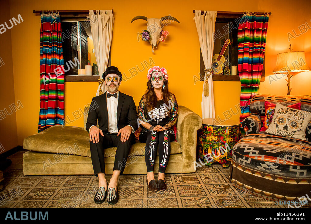 Man and woman in Dia de los Muertos makeup and costume, Day of the Dead celebration in the desert, California, United States of America, North America.