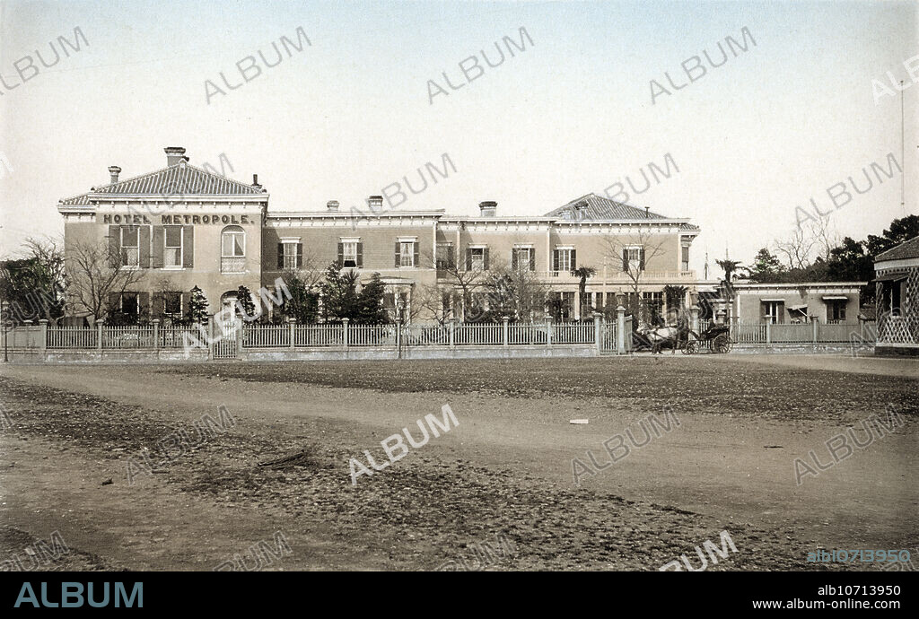 [ 1890s Japan - Western-Style Hotel in Tokyo ] The Hotel Metropole in the foreign settlement of Tsukiji, Tokyo. Collotype photograph from "Scenes in the Eastern Capital of Japan" published by Kazumasa Ogawa in 1895 (Meiji 28). Original text: "The Hotel Metropole (Branch of Club Hotel Lt.) Tsukiji, Tokyo.". 19th century vintage collotype print.