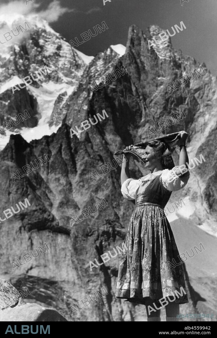 Woman in traditional costume. Courmayeur. Mont Blanc and the Aiguille Noire. valle d'aosta. Italy 1950-60.