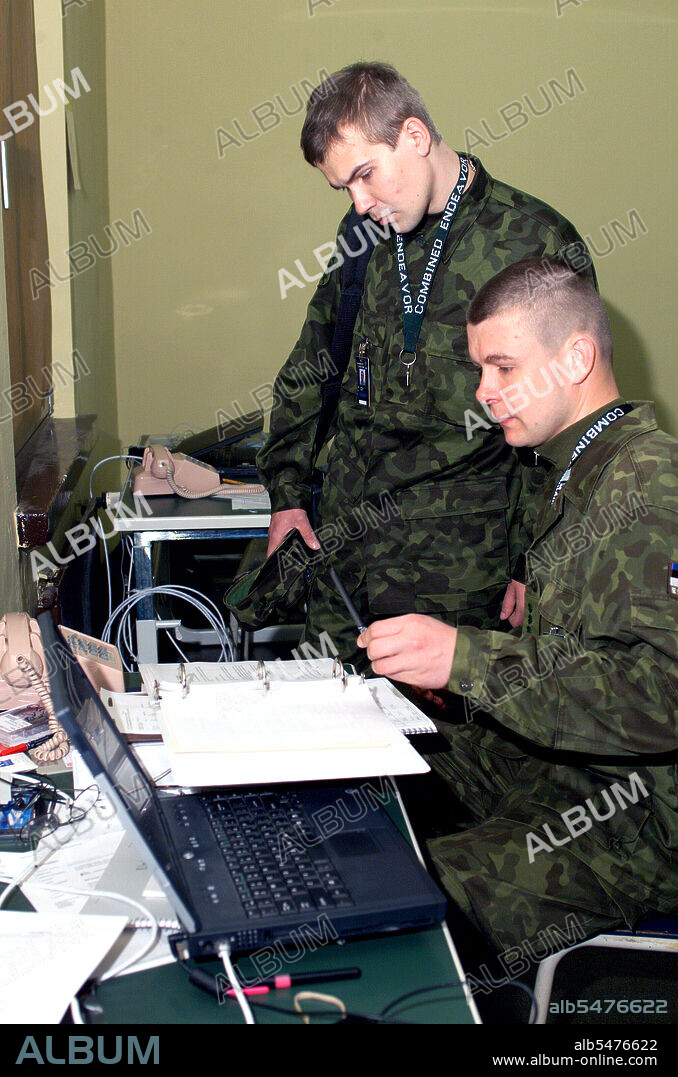 COMBINED ENDEAVOR (year 2000 or 2003) - Estonia Army Technical Specialists Captain (CPT) Daniel Meltsas (foreground) and CPT Andres Hairk, assign computer network passwords, during the US European Command (USEUCOM) -sponsored Exercise COMBINED ENDEAVOR, held at Lager Aulenbach, Germany.