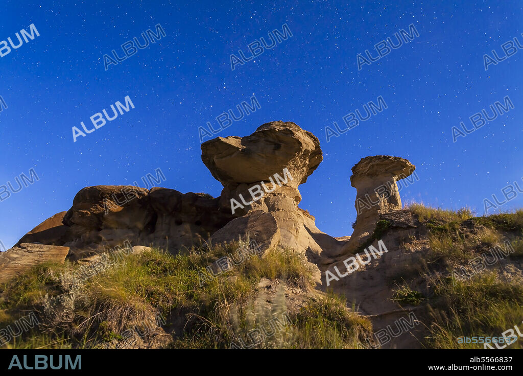 August 18, 2013 - The stars of Cassiopeia and Andromeda rising behind hoodoo formations at Dinosaur Provincial Park, Alberta, Canada. Illumination is from the waxing gibbous moon (off camera).