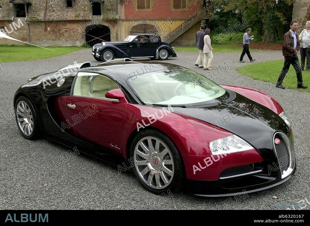 (dpa) - A model of the new Bugatti luxury car EB 16.4 Veyron stands in front of the former Bugatti Castle in Molsheim, France, 15 September 2002. In the background a Bugatti veteran car. The foundation stone of a Bugatti factory had been laid on 15 September; from 2004, fifty of the luxury cars will be handcrafted per year in the new factory in Molsheim. With a maximum velocity of 406 km per hour it is the fastest car authorized for traffic. 15/09/2002