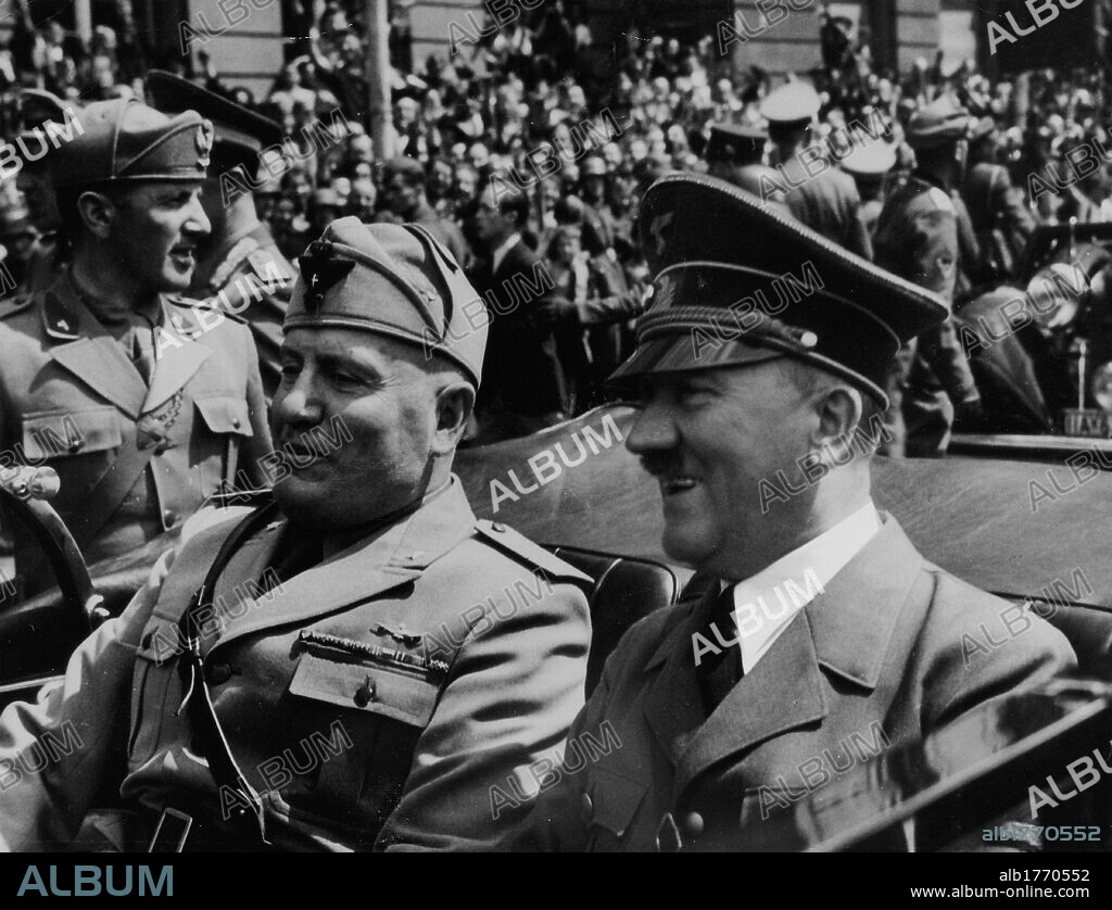 Benito Mussolini and Adolf Hitler aboard a car. The head of Fascist government Mussolini sitting on a car next to the Fuehrer of the Third Reich Adolf Hitler. 1930s.