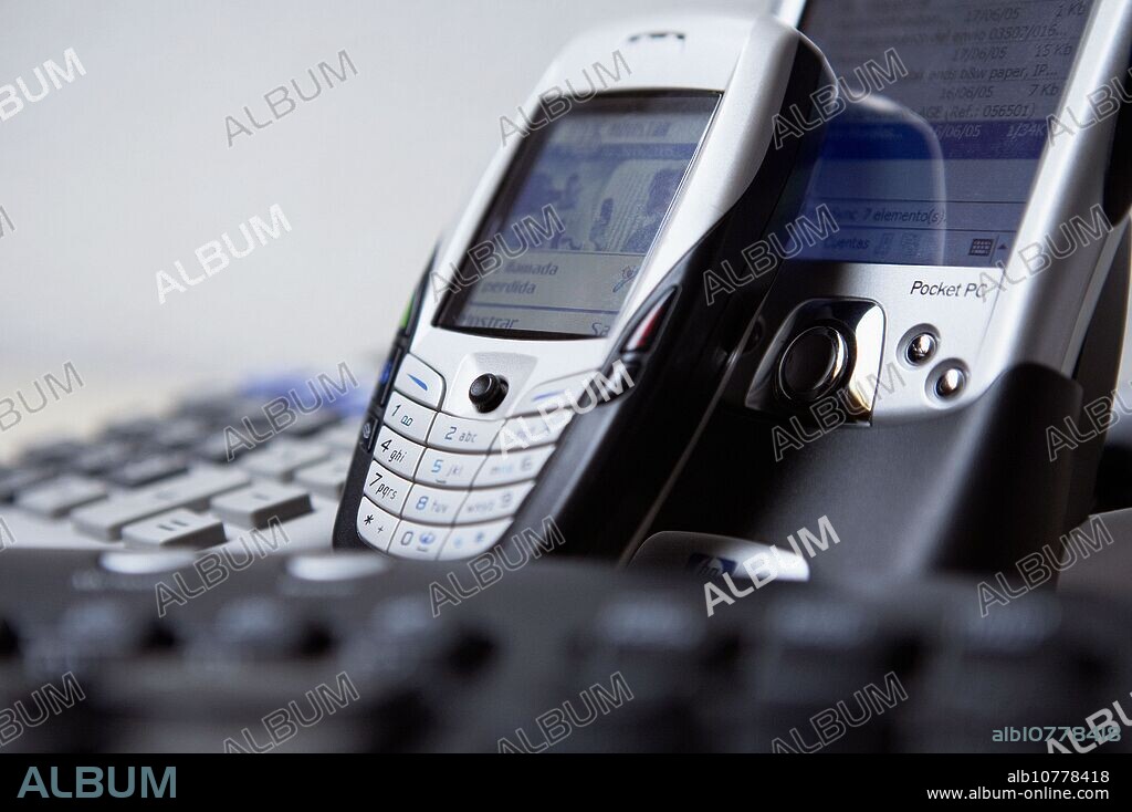 Cell phone and PDA Pocket PC with bluetooth, calculator and PC keyboard.