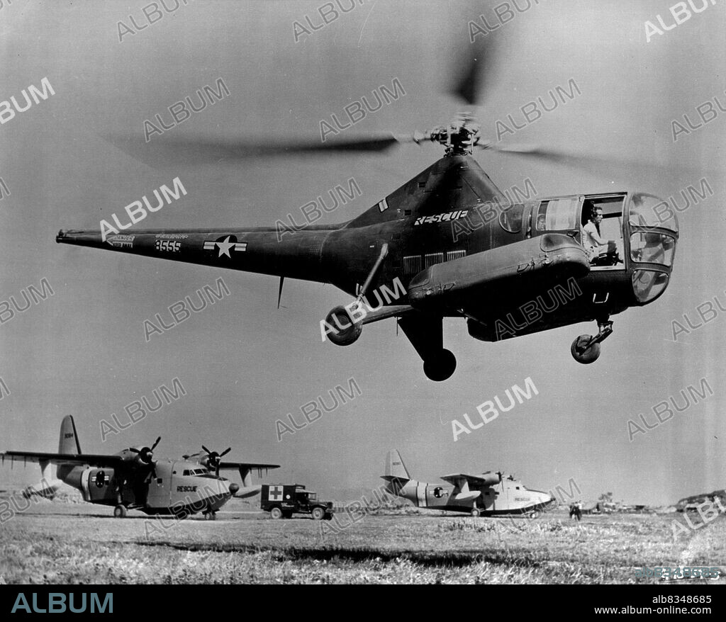 Two Types Of Rescue Aircraft -- Two types of 3rd Air Rescue Squadron aircraft are shown here. The H-5 helicopter in the foreground is used primarily to pick up downed crewmen and wounded personnel from Frontline areas as well as behind enemy lines. In the rear are SA-16 amphibians which are used in rescuing UN personnel downed at sea. Over 4800 rescues have been made by these rescue aircraft during the two years of the Korean war. June 21, 1952. (Photo by U.S. Air Force Photo).