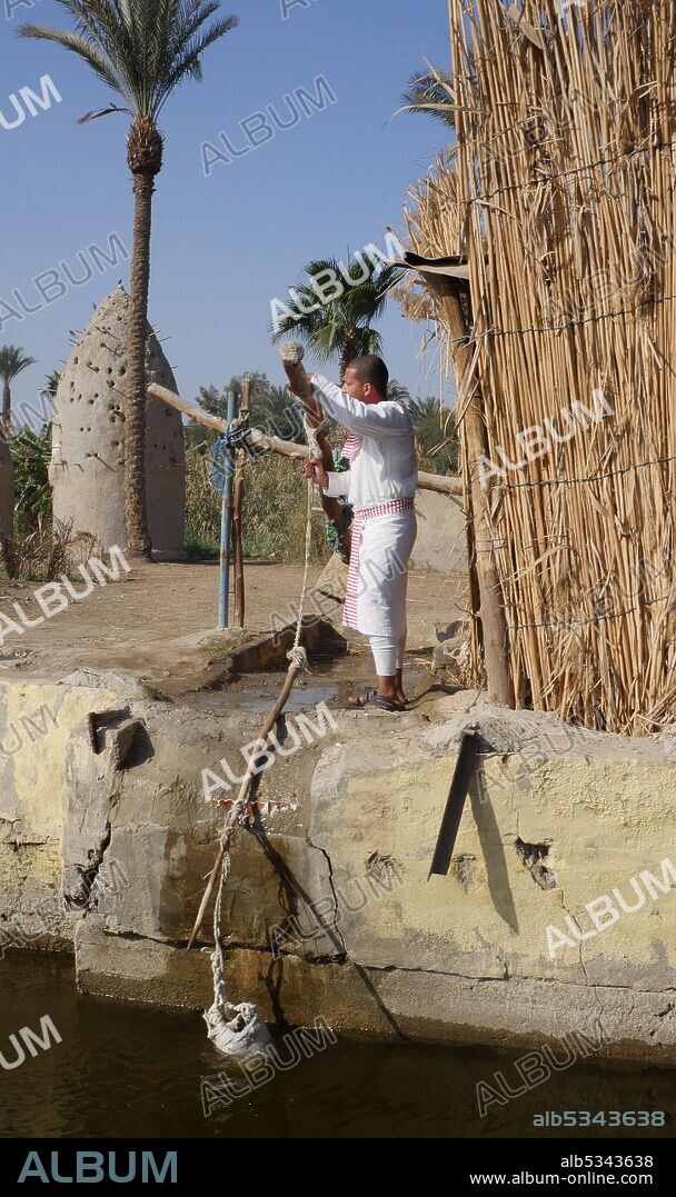 Replica of an ancient Egyptian village with a shadoof or shaduf, irrigation tool. The shadoof was an early tool used in irrigation by the ancient Egyptians who lived along the Nile River and the Mesopotamians..