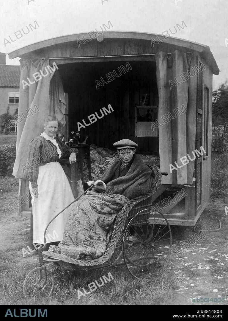 A boy or young man, suffering from pulmonary tuberculosis, sits in a Bath chair in front of his chalet accompanied by a woman (presumably his mother). The chalet contains a bed and a chair and is open, possibly to allow fresh air to circulate for the benefit of the inhabitant. Published in 1900. A Bath chair is a rolling chaise or light carriage with a folding hood. Used especially by invalids, it is mounted on three or four wheels and drawn or pushed by hand. It is so named from its origin in Bath, England, and possibly also after its similarity in appearance to an old-fashioned bathtub.