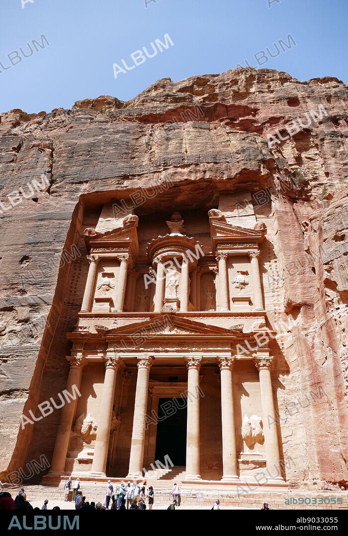 Al-Khazneh (The Treasury) a temple in the ancient Nabatean Kingdom city of Petra, Jordan. The structure was carved out of a sandstone rock face and is believed to have been the mausoleum of the Nabatean King Aretas IV in the 1st century AD. It is one of the most popular tourist attractions in both Jordan and the region. In 1812, the city of Petra and Al-Khazneh was rediscovered by Swiss explorer Johann Ludwig Burckhardt.
