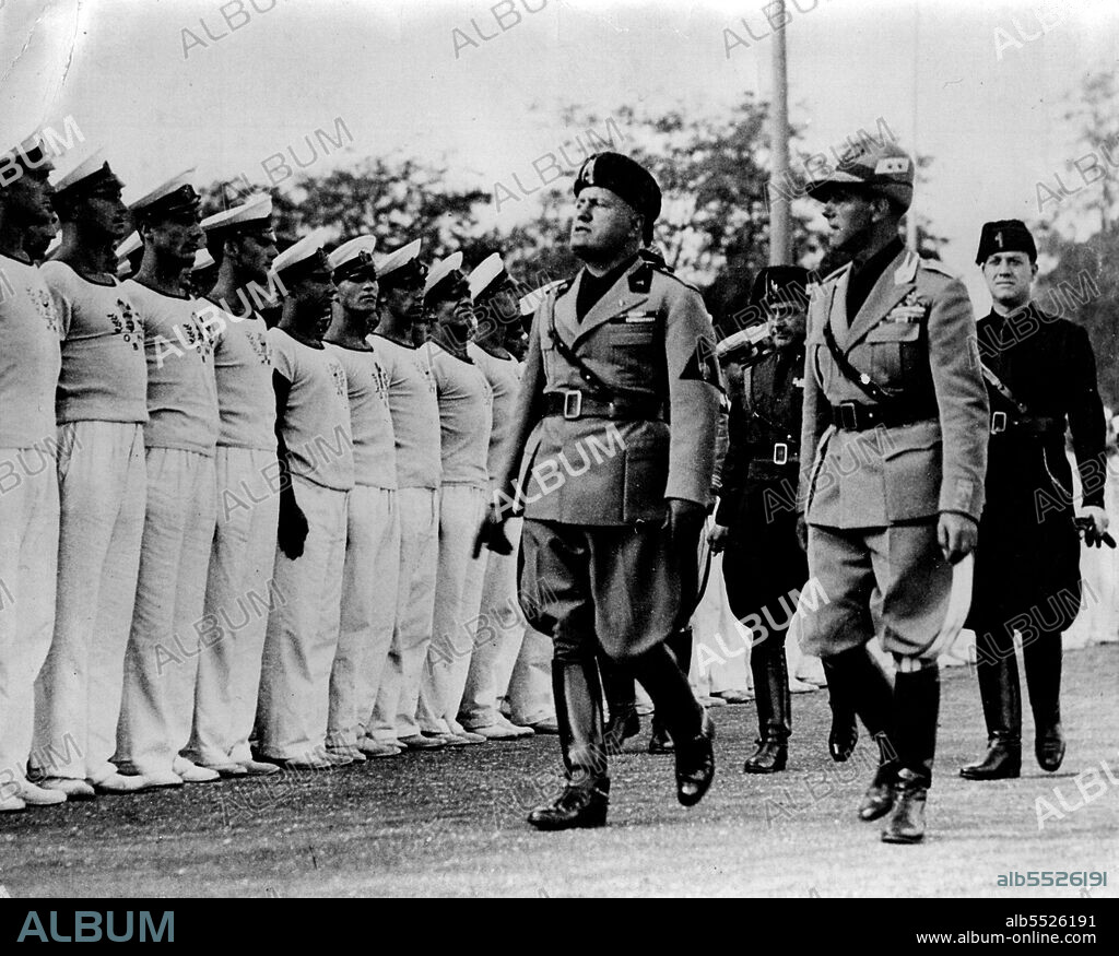 The Duce Reviews Young Fascists:Mussolini reviewing Avanguardisti at Campo Dux. On right, in light uniform, is ihis son-in-law, Count Galeazzo Ciano, the new Minister of Propaganda.Thirty thousand members of the Avanguardia (whose ages range from 14 to 18) are receiving annual military training at the Campo Dux. Signer Mussolini recently visited the camp and held inspections of the youthful Facists.October 28, 1934. (Photo by The Associated Press of Great Britain Ltd.).
