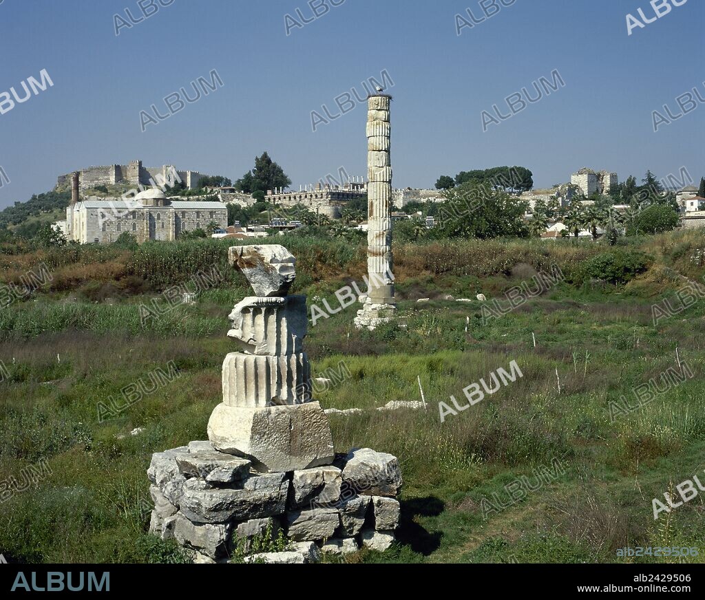 Turkey, Ephesus (modern Seluk). Temple of Artemis or Artemision. Greek temple. One of The Seven Wonders of the Ancient World. Remains of the colossal column. In the background Isa Bey Mosque and the Byzantine Castle.
