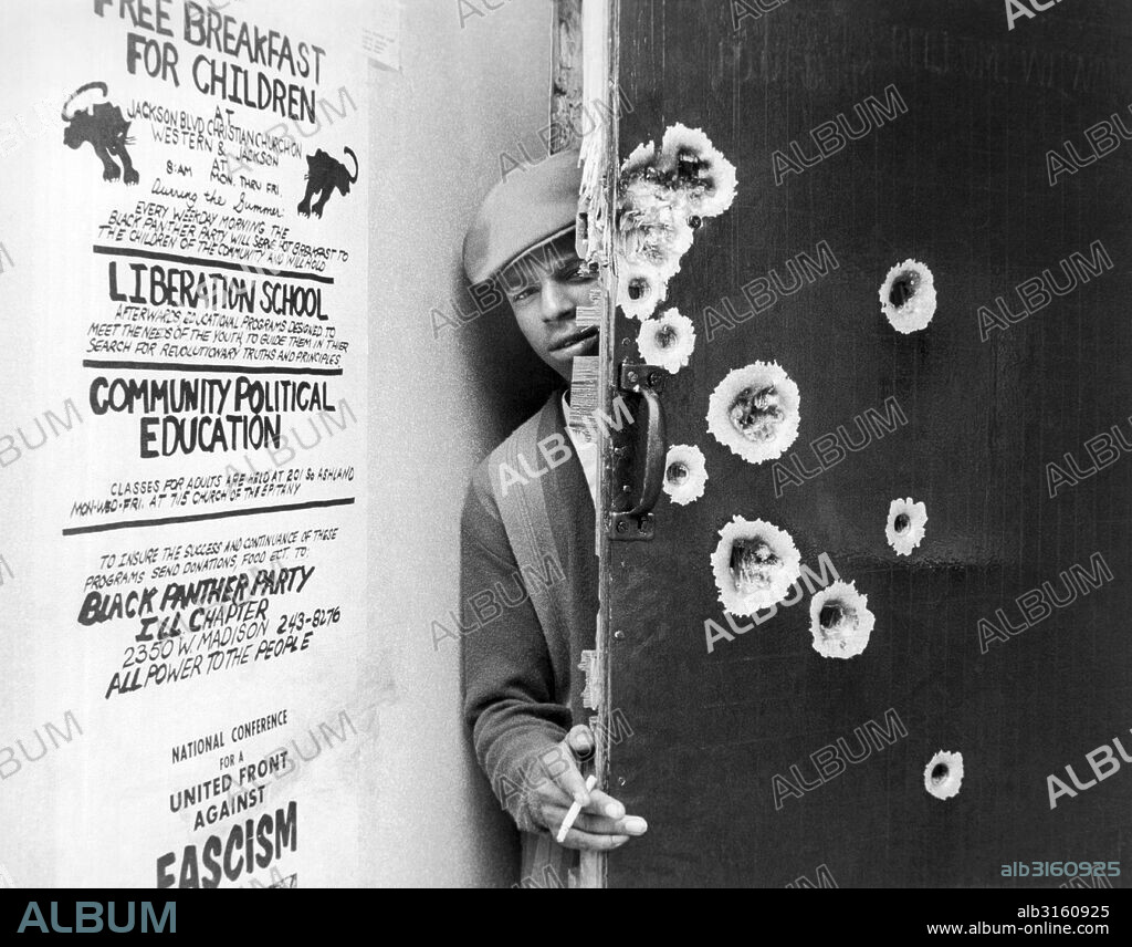 Chicago, Illinois: October, 1969 A Black Panther at the street door to their headquarters after the October police raid.